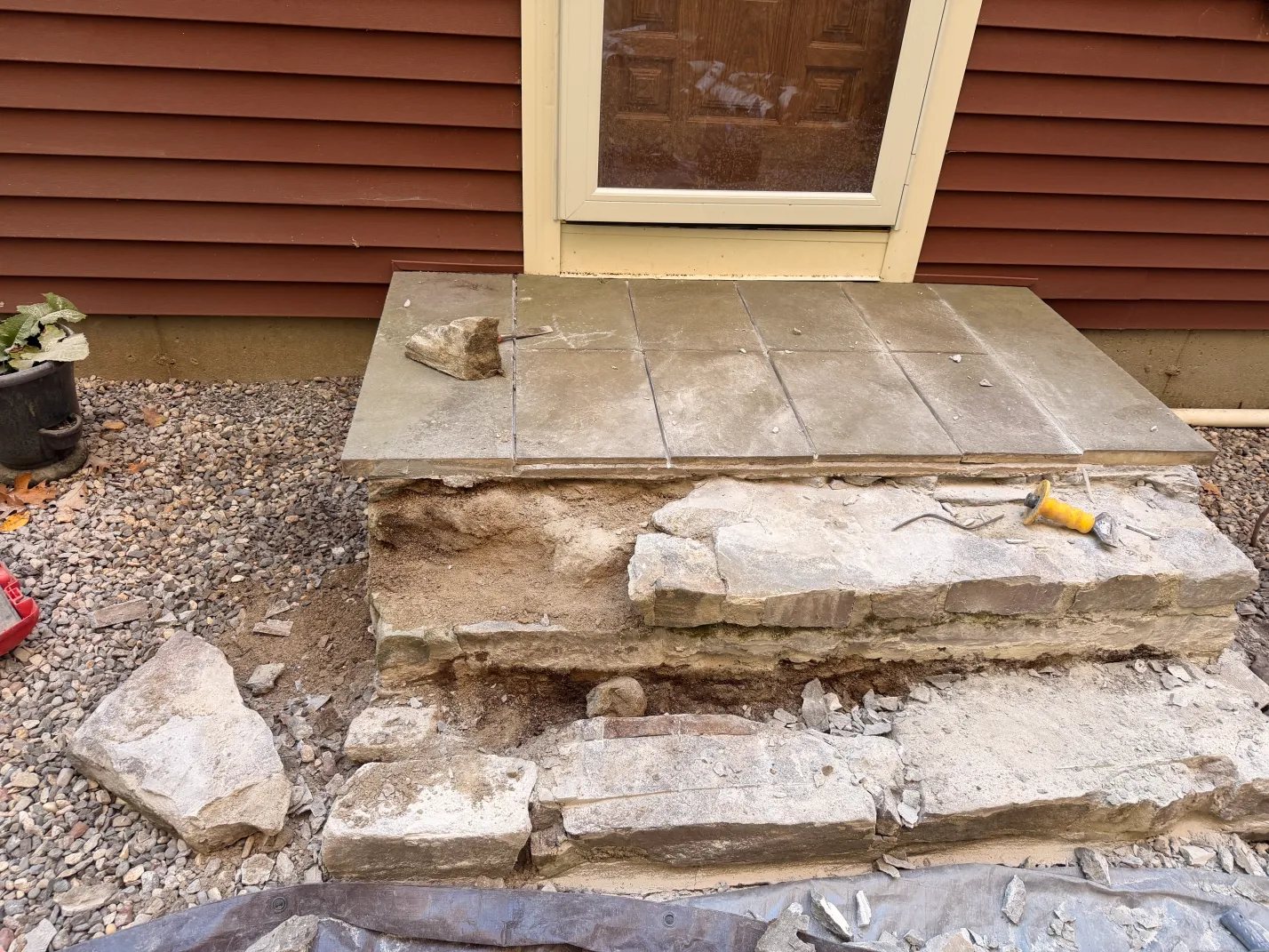 Bluestone front stoop rebuild in progress — stone base exposed, Palmer, MA