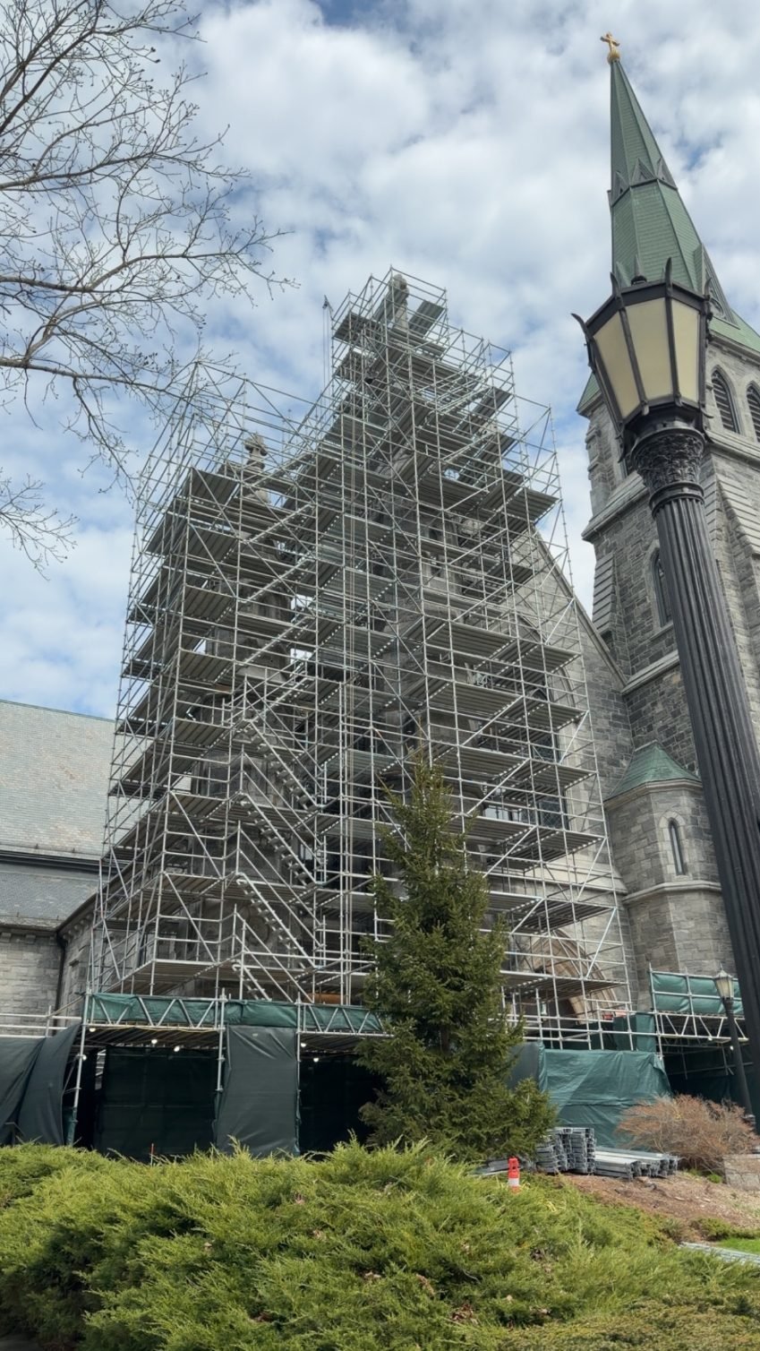 Historic church tower under full restoration scaffolding